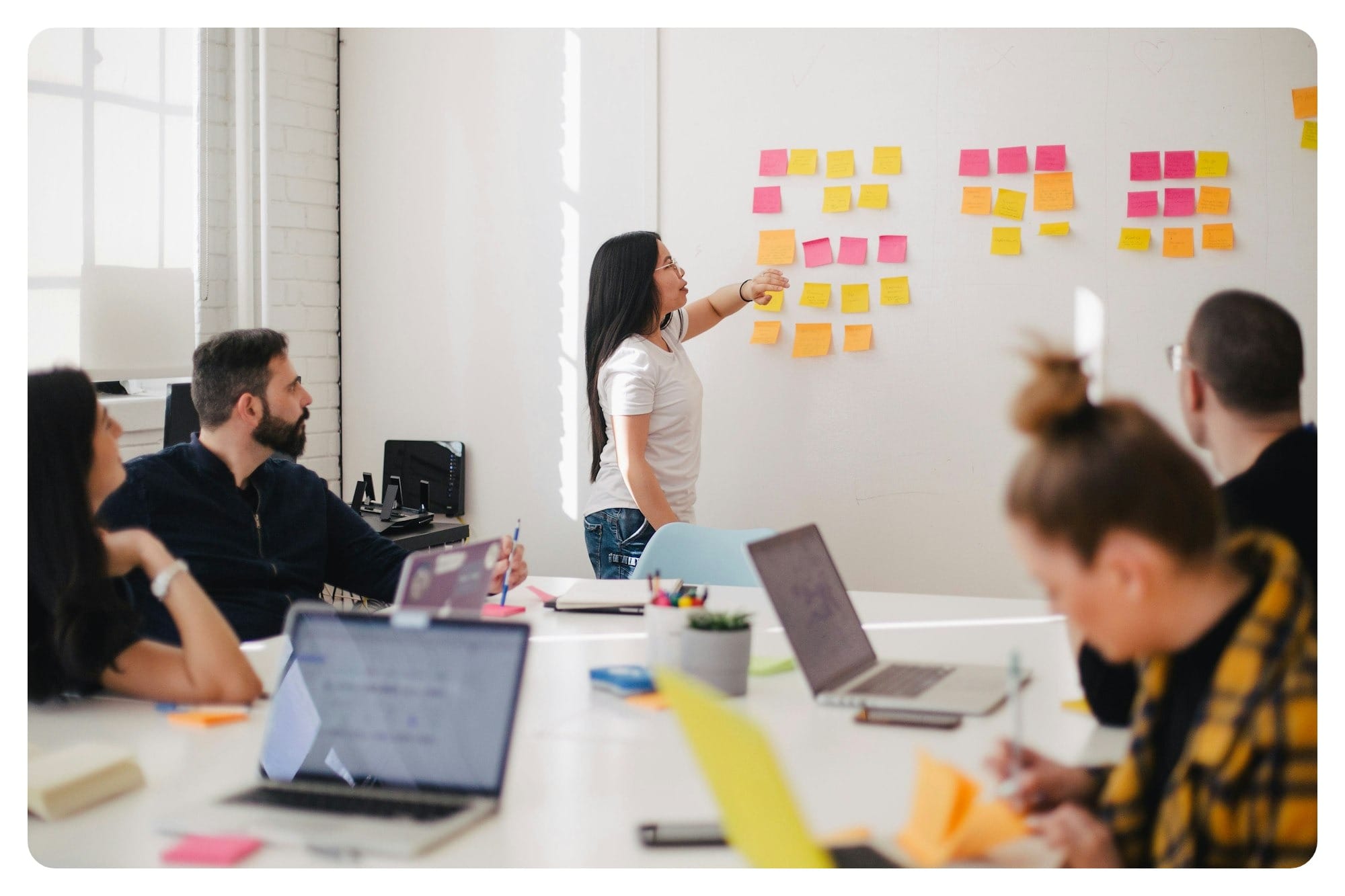 woman placing sticky notes on wall