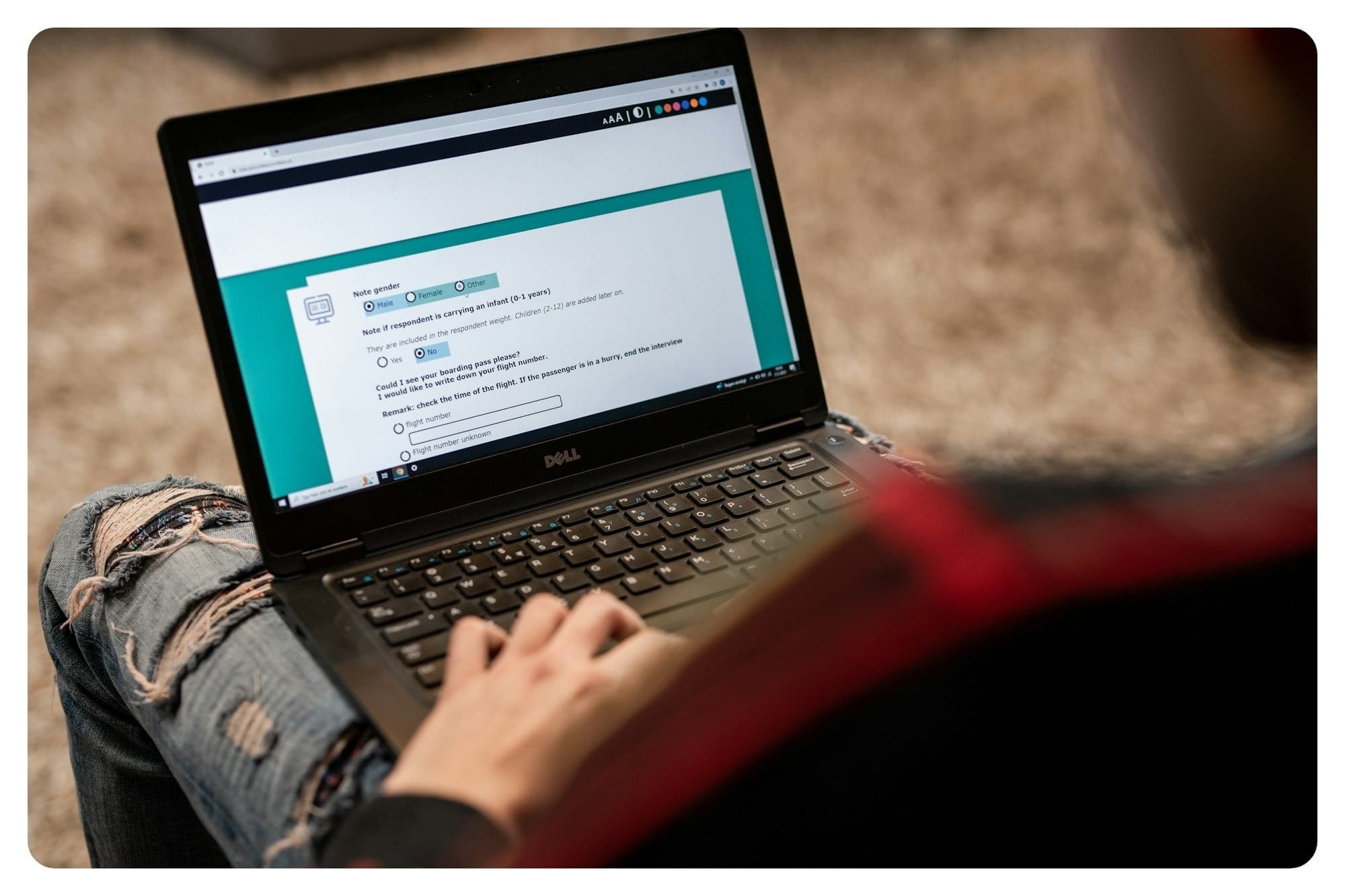 a person sitting on the floor using a laptop